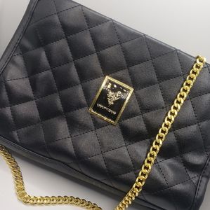 Younique branded black purse with gold chain.